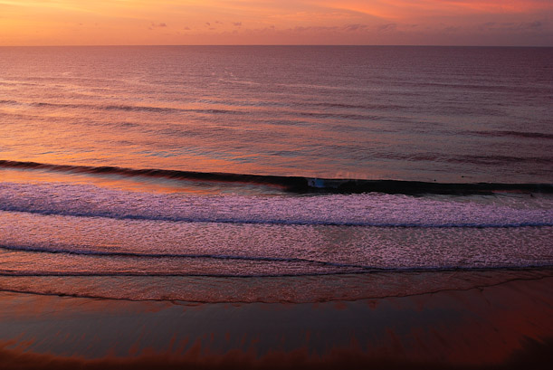 Sunset over Los Locos. Surfing waves in Spain