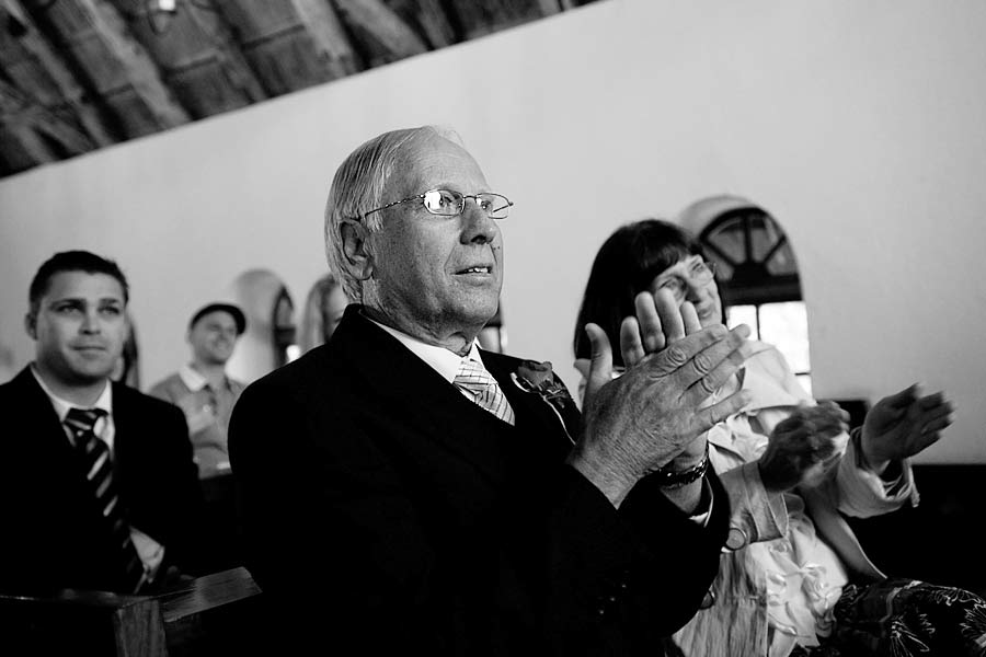 Father of the Bride claps at the wedding ceremony
