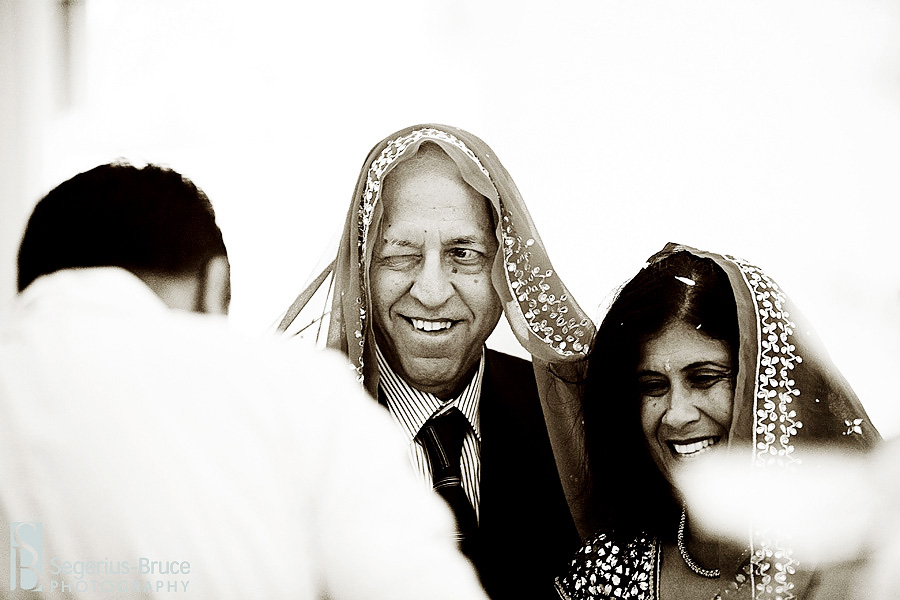 Bride\'s father winking at family during hindu marriage ceremony