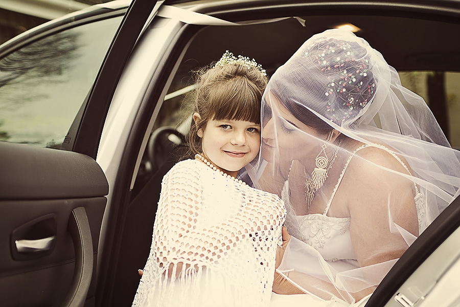 Reportage wedding photography of flower girl with bride
